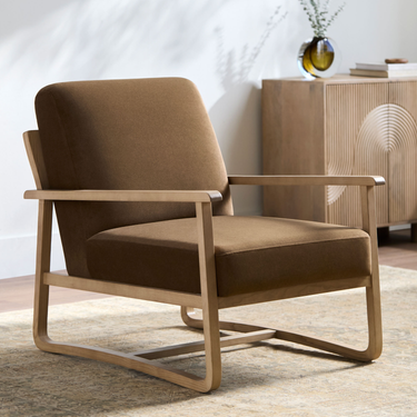 Brown armchair with wooden frame in a room setting