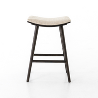 A modern bar stool with a dark brown solid base and a beige upholstered seat cushion.