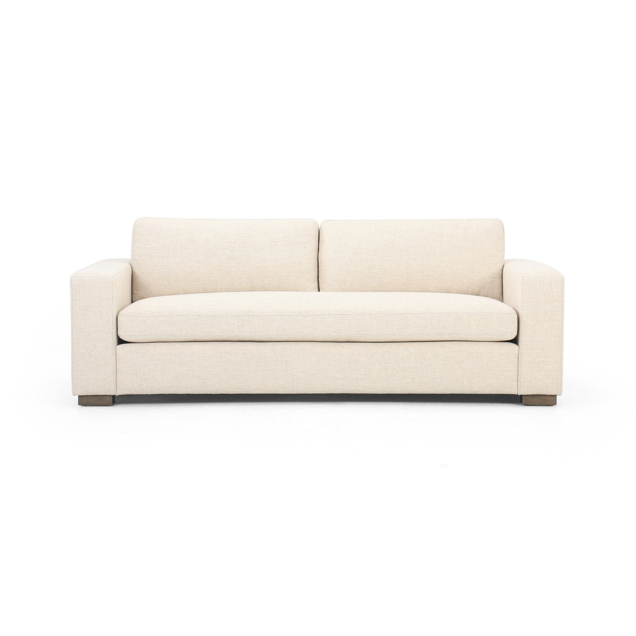 A beige Vero Sofa with a simple and modern design, featuring a low profile and square arms, set against a white background.