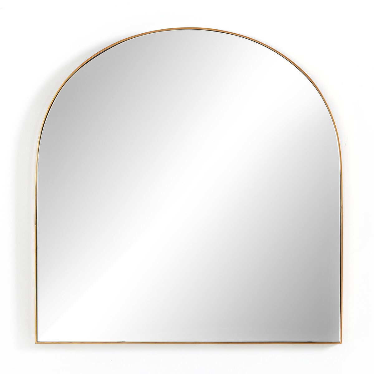 An arched mirror with a gold frame, reflecting a white wall and ceiling.