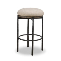 Bar stool with beige cushioned seat and black metal frame on a white background