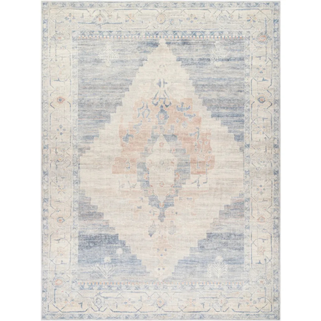 A traditional denim/navy area rug with a geometric pattern, crafted in Turkey.