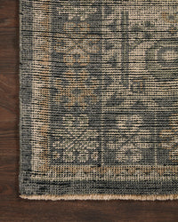 Close-up of a textured rug with geometric pattern on a wooden floor.
