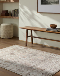 Living room with a wooden bench, rug, and decor items.
